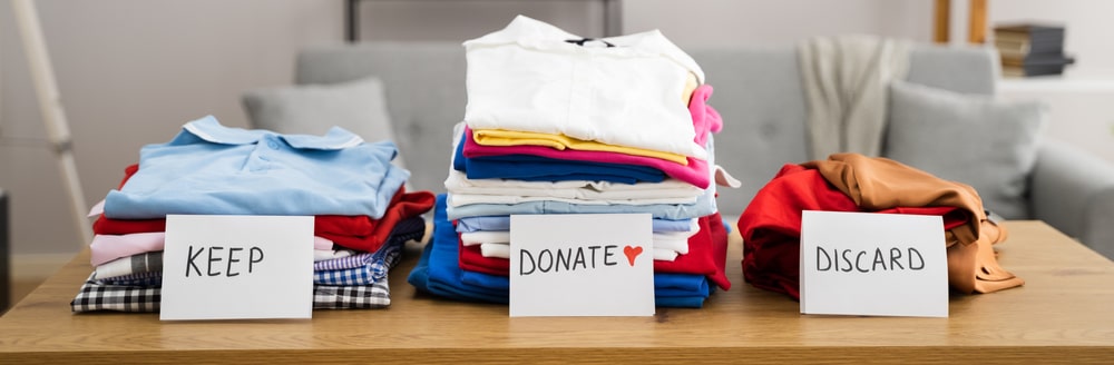 Clothes stacked into neat piles for donation