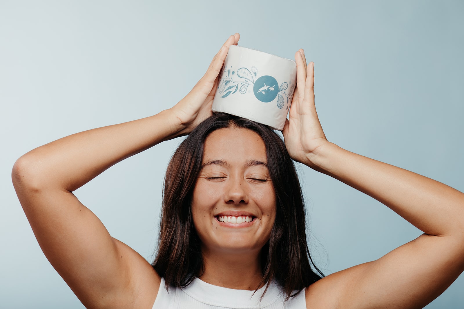 Lady smiling with Pure Planet Club Eco Toilet Paper on her head